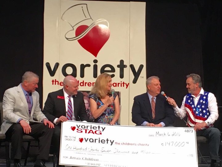 Rick Ball helps present a $147,000 check to Variety Iowa